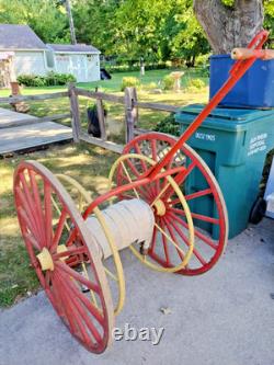 Antique Hand Drawn Fire Hose Transporter with Hose and nozzle
