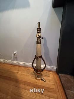 Vintage Larkin brass and rubber play pipe fire nozzle with leather hds. 34 In. H