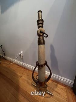 Vintage Larkin brass and rubber play pipe fire nozzle with leather hds. 34 In. H