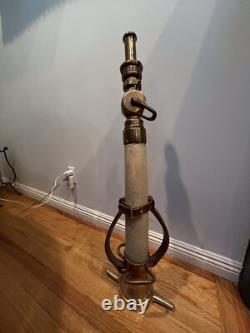 Vintage Larkin brass and rubber play pipe fire nozzle with leather hds. 34 In. H