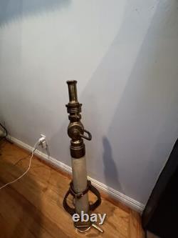 Vintage Larkin brass and rubber play pipe fire nozzle with leather hds. 34 In. H