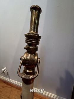 Vintage Larkin brass and rubber play pipe fire nozzle with leather hds. 34 In. H