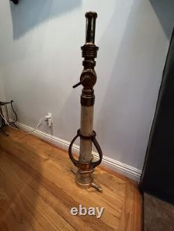 Vintage Larkin brass and rubber play pipe fire nozzle with leather hds. 34 In. H